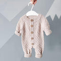 Pink herringbone baby romper with button front and ribbed cuffs