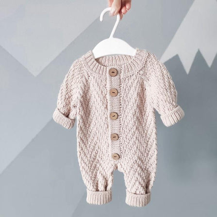 Pink herringbone baby romper with button front and ribbed cuffs