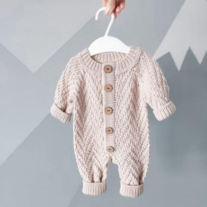 Pink herringbone baby romper with button front and ribbed cuffs