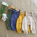 Stork baby jumpsuit knitting pattern — finished knitted outfits, view 1